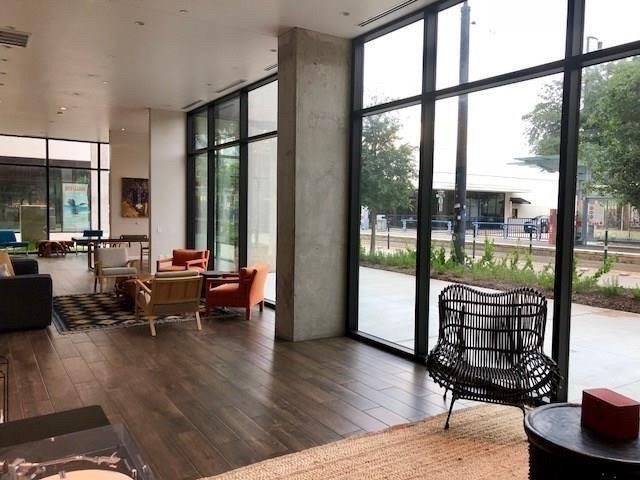 3550 Main Street, Unit 4415 Houston, TX 77002 - Photo 14 of 46 a living room with furniture and a floor to ceiling window
