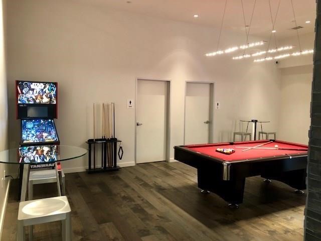 3550 Main Street, Unit 4415 Houston, TX 77002 - Photo 24 of 46 a dining room with wooden floor and chandelier
