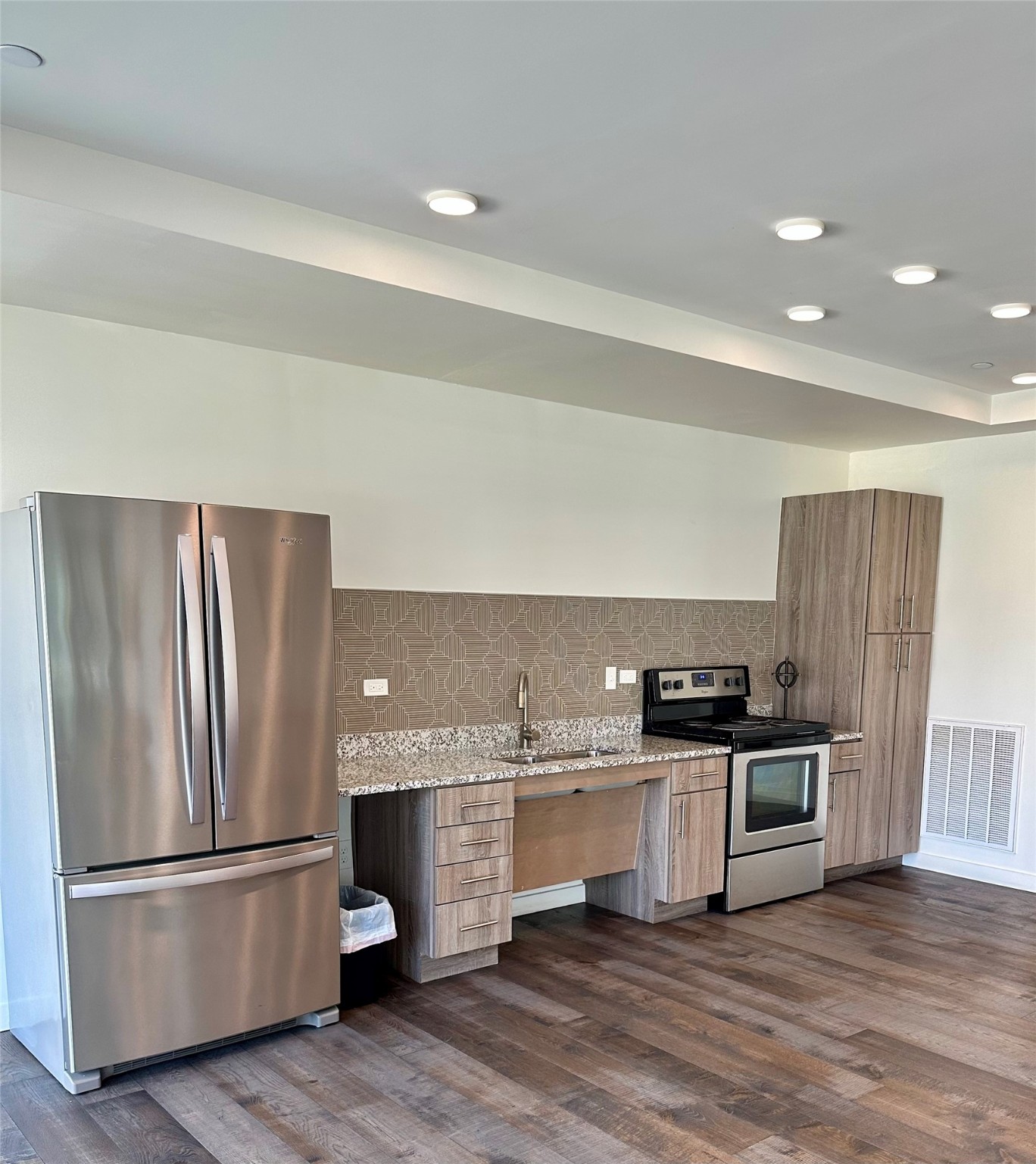 3550 Main Street, Unit 4415 Houston, TX 77002 - Photo 29 of 46 a kitchen with stainless steel appliances a refrigerator and wooden floor