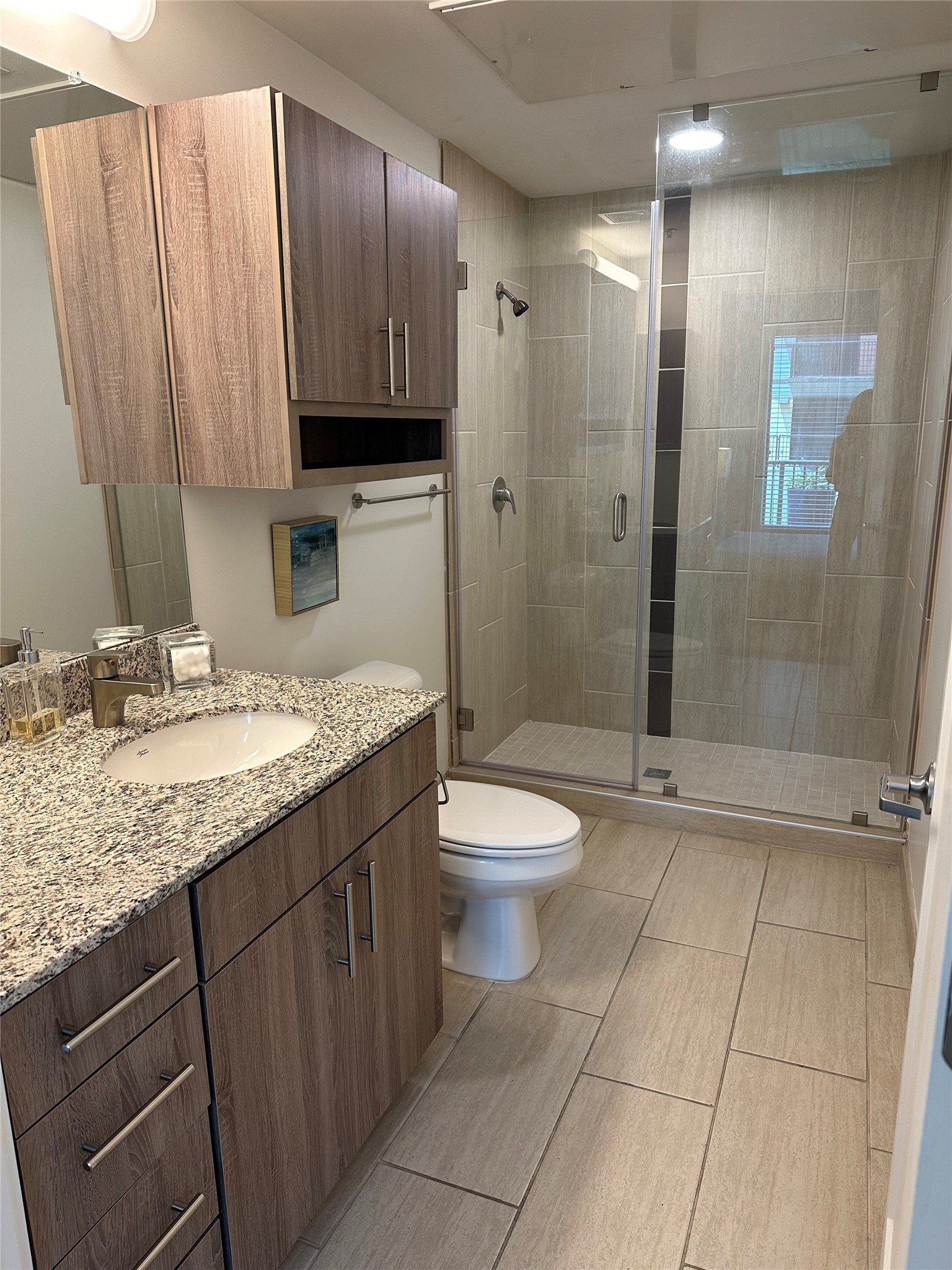 3550 Main Street, Unit 7107 Houston, TX 77002 - Photo 6 of 46 a bathroom with a granite countertop sink a toilet and shower