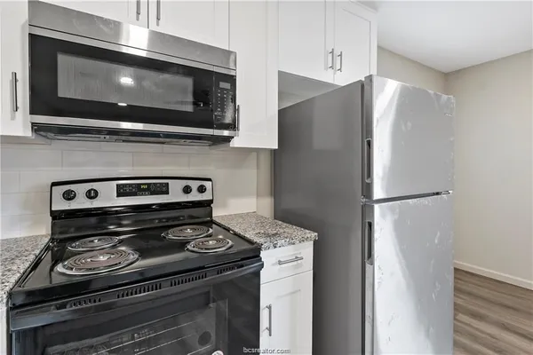 a kitchen with stainless steel appliances granite countertop a refrigerator stove a sink and dishwasher