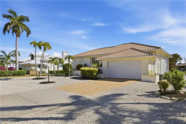 a view of a house with outdoor space and palm trees