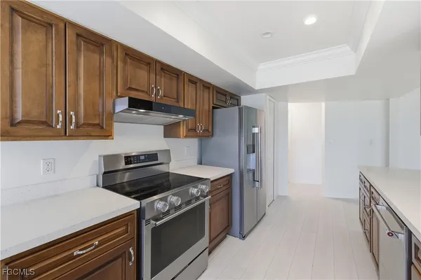 a kitchen with stainless steel appliances granite countertop a sink stove and cabinets