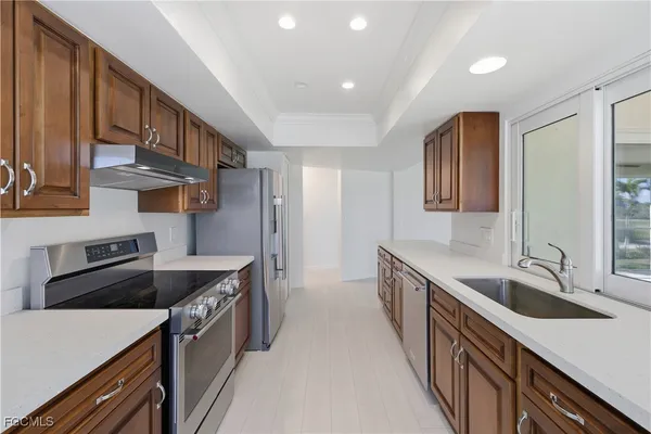 a kitchen that has a sink and a stove