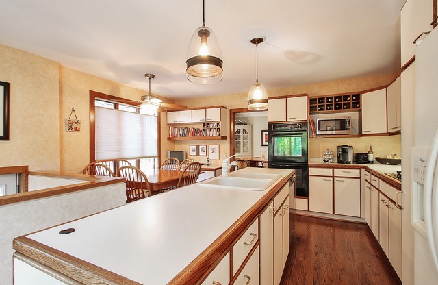 7 Wisner Street Park Ridge, IL 60068 - Photo 8 of 20 a kitchen with stainless steel appliances granite countertop a sink a stove and a refrigerator