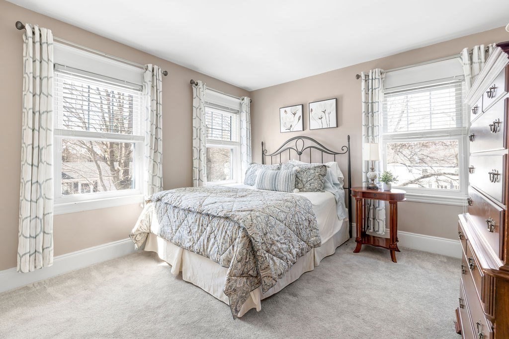 60 High Street Needham, MA 02494 - Photo 16 of 32 a spacious bedroom with a bed and a large window with the outer view