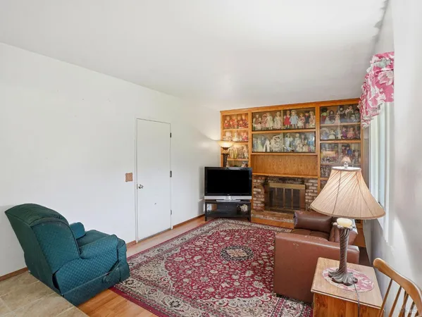 a living room with furniture a rug and a flat screen tv