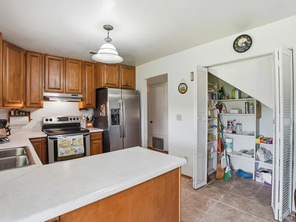 a kitchen with a refrigerator a stove and a sink