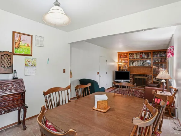a dining room with furniture a rug and wooden floor