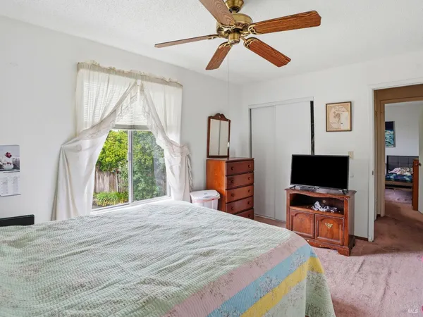 a bedroom with a bed and a flat screen tv