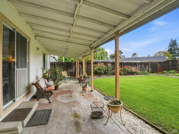 a view of yard with patio