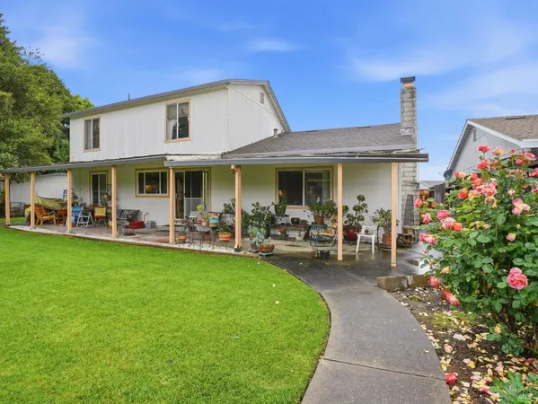 a front view of a house with garden and patio