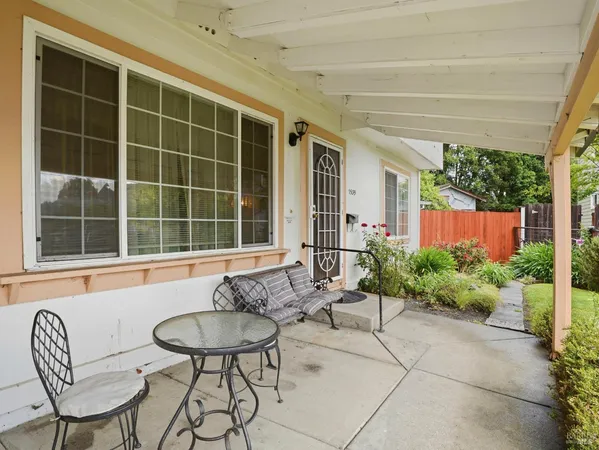 a view of a house with backyard and sitting area
