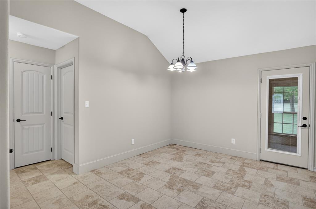 505 East 5th Street Springtown, TX 76082 - Photo 13 of 39 a view of an empty room with chandelier fan