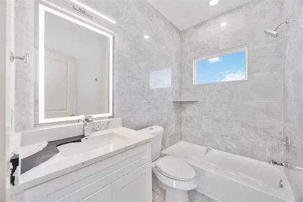 a bathroom with a sink a toilet and a bathtub