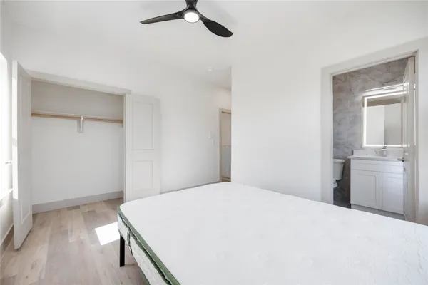 a bedroom with a bed and cabinets