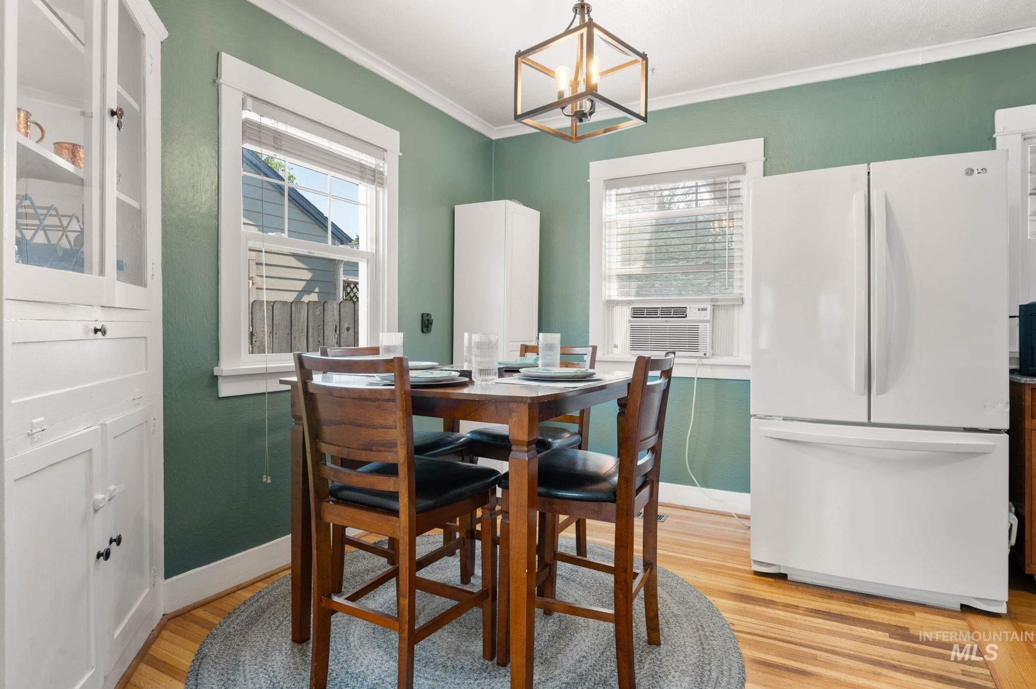 907 3rd Street Lewiston, ID 83501 - Photo 14 of 26 Dining room with light wood-type flooring, hanging lights, ornamental molding, and cooling unit