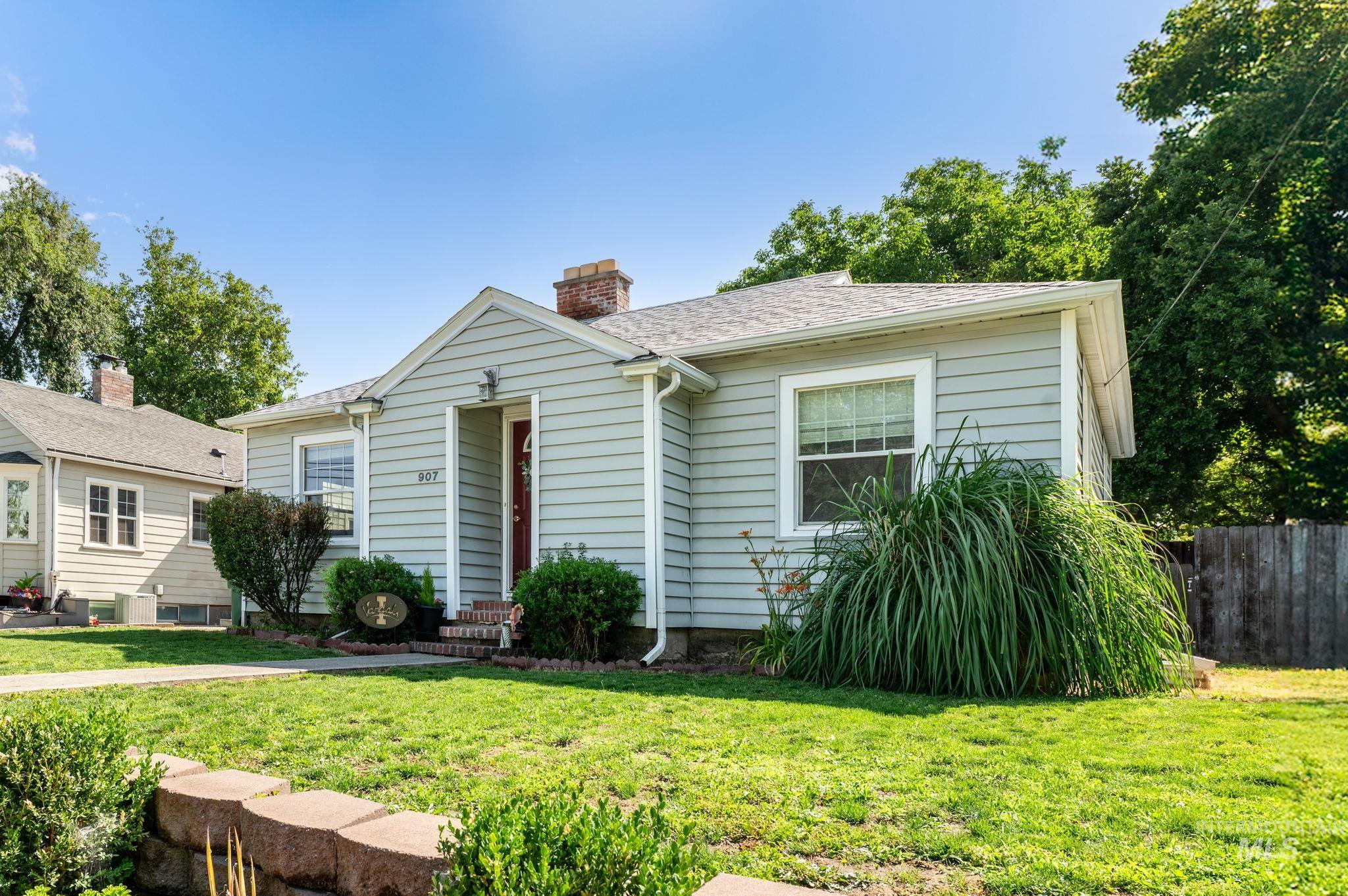 907 3rd Street Lewiston, ID 83501 - Photo 2 of 26 Bungalow-style home featuring a shingled roof and a chimney