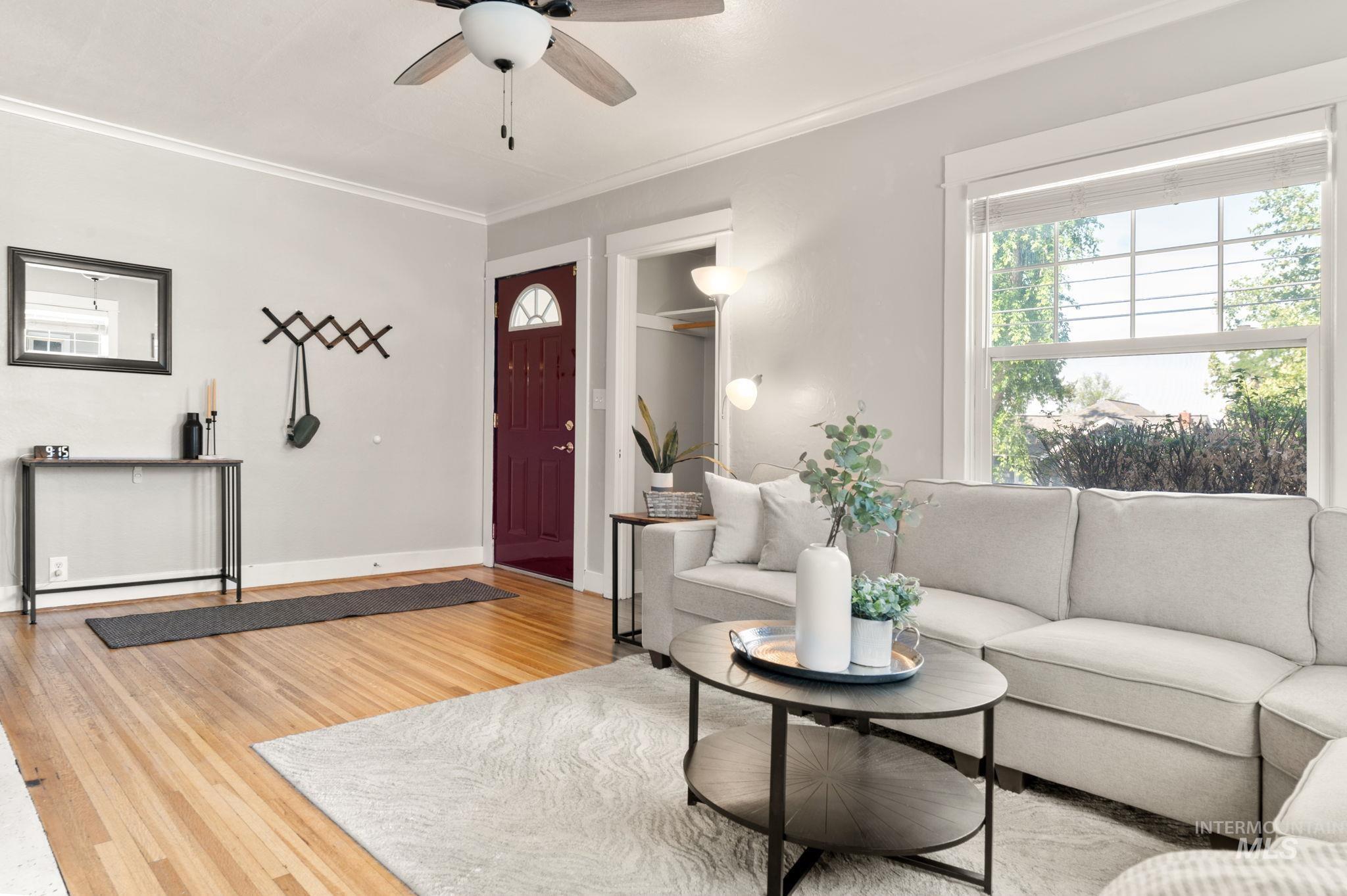 907 3rd Street Lewiston, ID 83501 - Photo 6 of 26 Living room featuring light wood finished floors, ornamental molding, and a ceiling fan