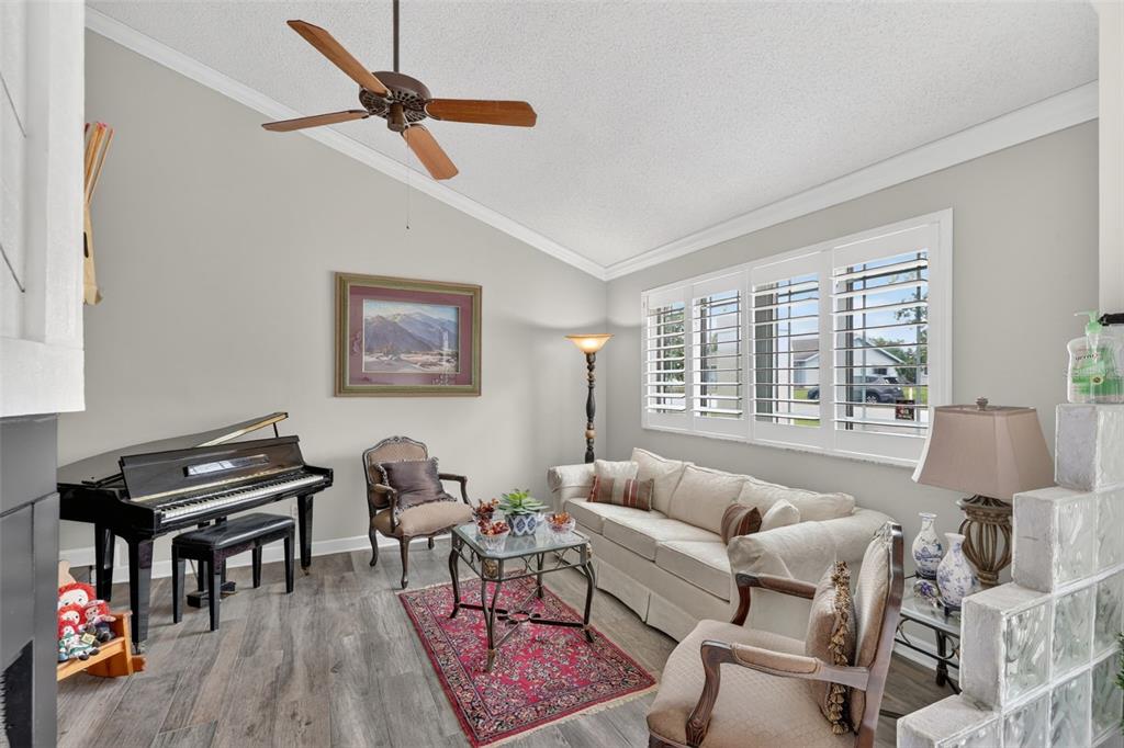 575 Tiberon Cove Road Longwood, FL 32750 - Photo 9 of 56 a living room with furniture a flat screen tv and a window