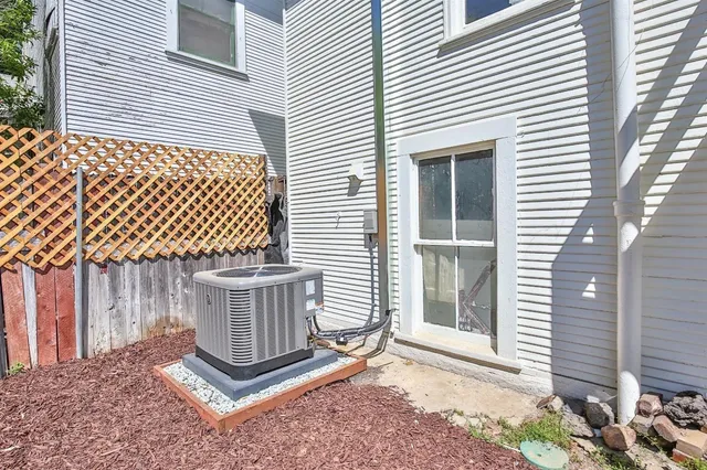 a view of a small house with backyard and a porch