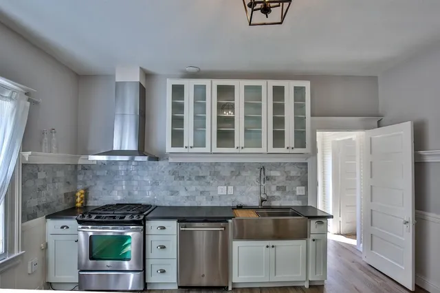 a kitchen with stainless steel appliances granite countertop a stove and a refrigerator