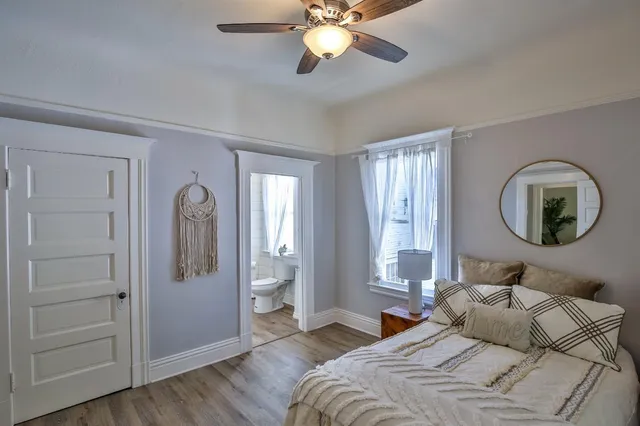 a bedroom with a bed and a mirror