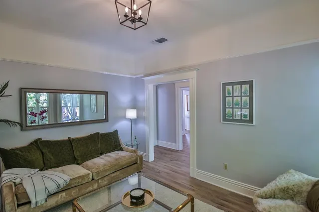 a living room with furniture a couch and dresser