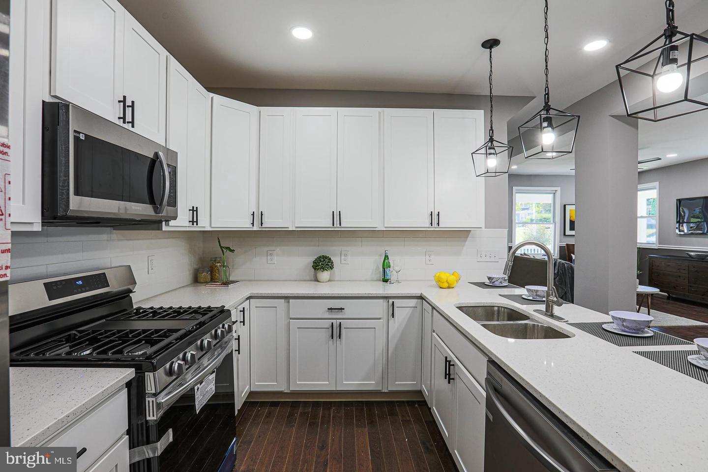 1904 Cedric Road Baltimore, MD 21216 - Photo 6 of 16 a kitchen with a sink a stove and cabinets
