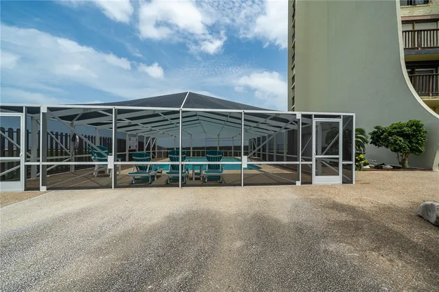 a view of a backyard with table and chairs