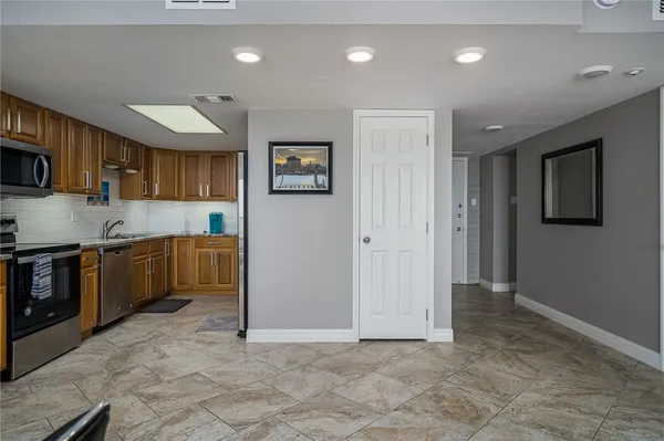 a kitchen with stainless steel appliances granite countertop a refrigerator sink and cabinets