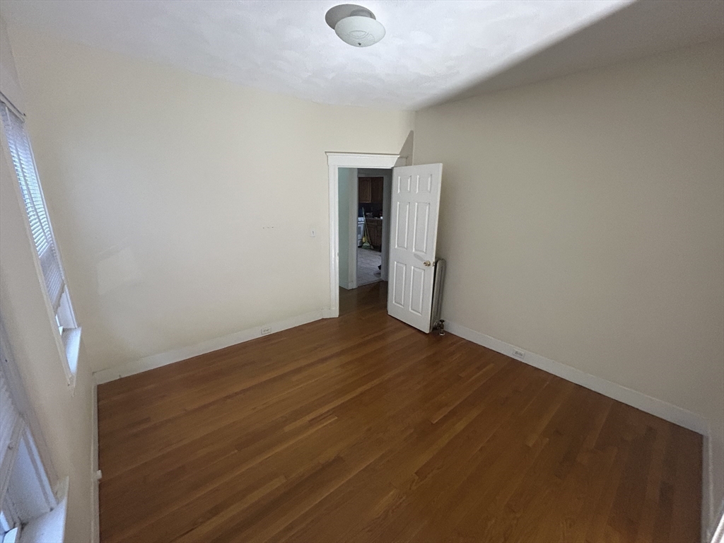 415 Washington Street, Unit 1 Winchester, MA 01890 - Photo 14 of 18 a view of empty room with wooden floor