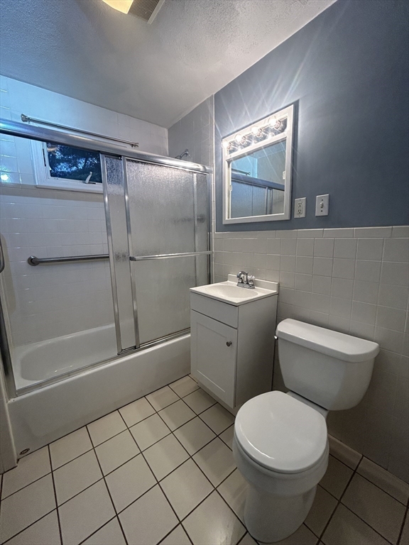 415 Washington Street, Unit 1 Winchester, MA 01890 - Photo 16 of 18 a bathroom with a toilet sink and mirror