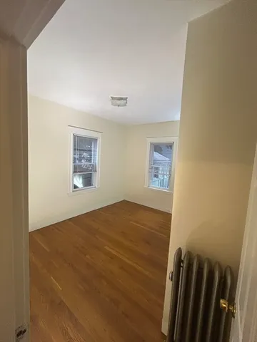 a view of an empty room and wooden floor