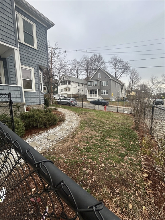 415 Washington Street, Unit 1 Winchester, MA 01890 - Photo 3 of 18 a house view with a outdoor space