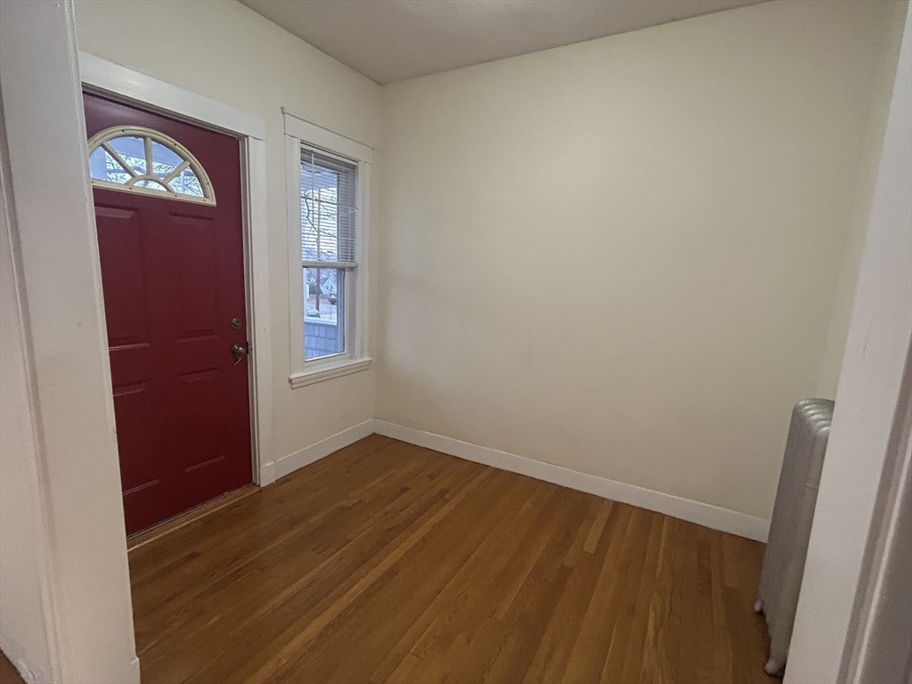 415 Washington Street, Unit 1 Winchester, MA 01890 - Photo 6 of 18 an empty room with windows and closet