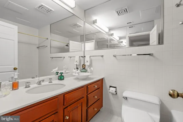 a bathroom with a sink a toilet and mirror