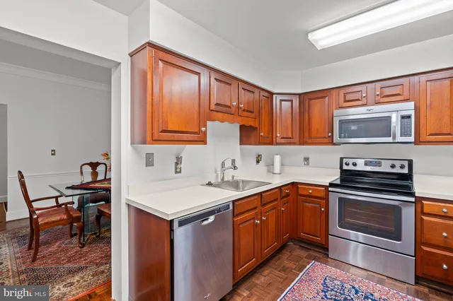 a kitchen with stainless steel appliances granite countertop a sink stove and microwave