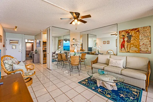 a living room with furniture a rug and a chandelier