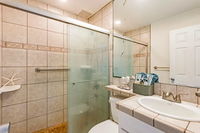 a bathroom with a sink mirror and toilet