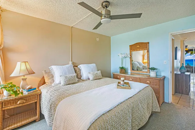 a bedroom with a bed and a painting on the wall