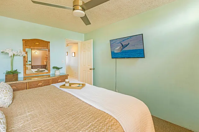 a bedroom with a bed and a large window