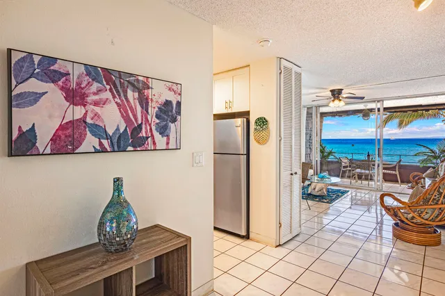 a living room with furniture a dining table and a painting on the wall