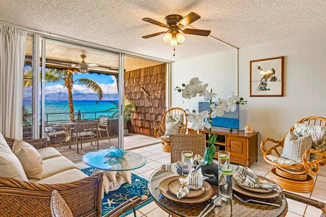 a view of a dining room with furniture a chandelier and a large window
