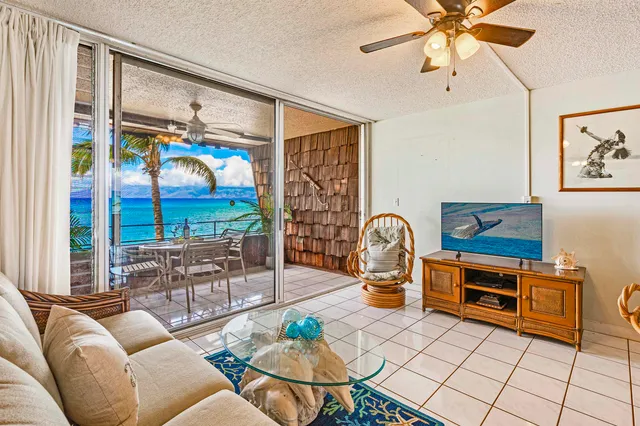 a living room with furniture a table and a large window
