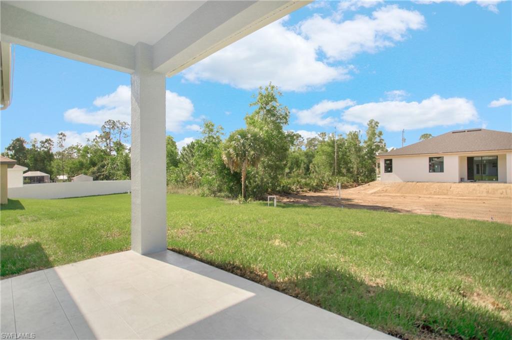 2811 14th Street West Lehigh Acres, FL 33971 - Photo 27 of 33 a view of a backyard with plants and large trees