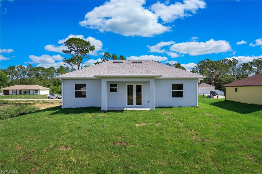 2811 14th Street West Lehigh Acres, FL 33971 - Photo 28 of 33 a front view of a house with a garden