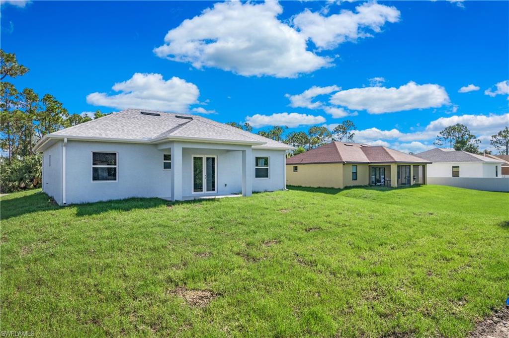 2811 14th Street West Lehigh Acres, FL 33971 - Photo 30 of 33 a view of a house with backyard and garden