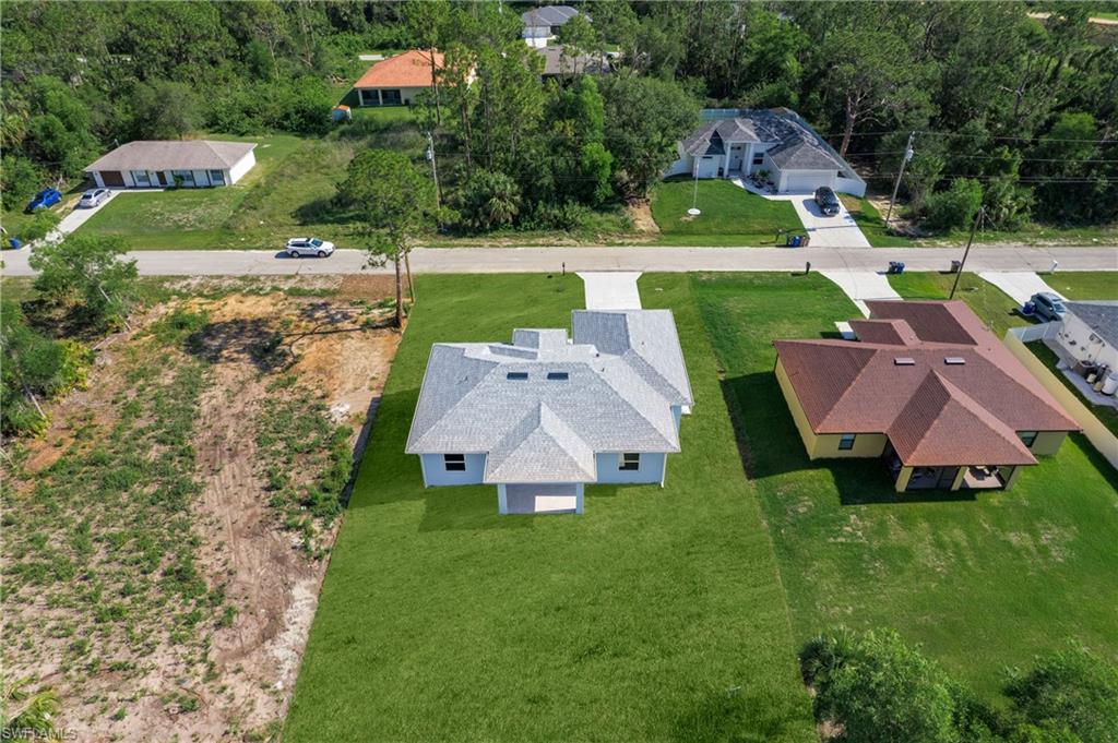 2811 14th Street West Lehigh Acres, FL 33971 - Photo 32 of 33 an aerial view of a house with yard swimming pool and outdoor seating