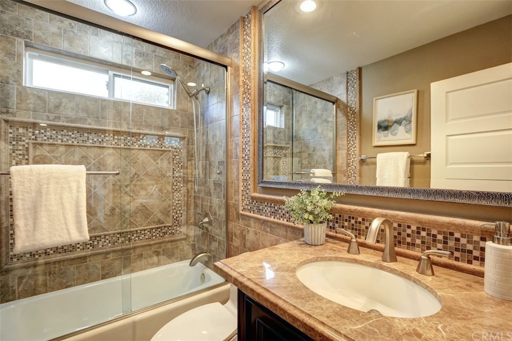 22805 Rio Lobos Road Diamond Bar, CA 91765 - Photo 24 of 50 a bathroom with a granite countertop tub sink toilet and a mirror